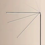 Several positions of the light bar on this Clérachic floor lamp are overlaid on a cream wall, from horizontal to steeply angled.