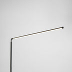 The same joint with the light bar switched on, giving a warm line of light along this Clérachic floor lamp, on a pale grey backdrop.