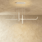 Clérachic white linear pendant switched on, its slim arm glowing softly beneath a rectangular canopy on a plastered wall.