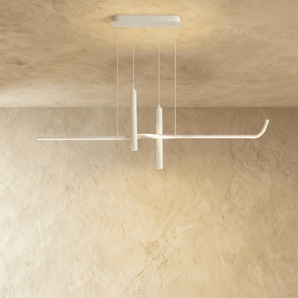 Clérachic white linear pendant switched on, its slim arm glowing softly beneath a rectangular canopy on a plastered wall.