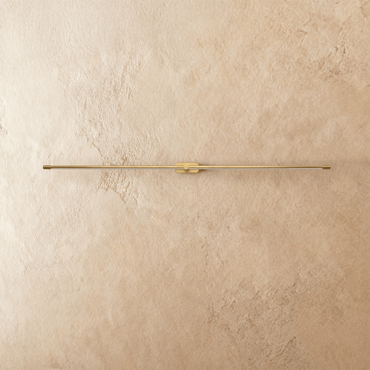 Clérachic ultra-slim linear wall light switched off, a gold aluminium bar with fluted end caps on a plaster wall.