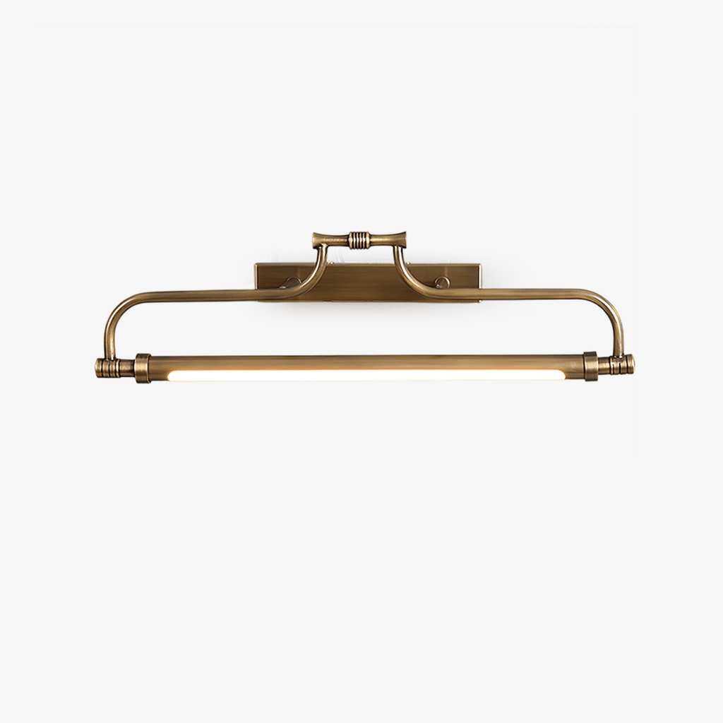 A Clérachic slim wall light in aged brass on a plain white backdrop, its curved arm and glowing tube seen straight on.