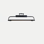 A black version of this Clérachic wall light on a pale grey backdrop, with the same arm and ribbed end caps.