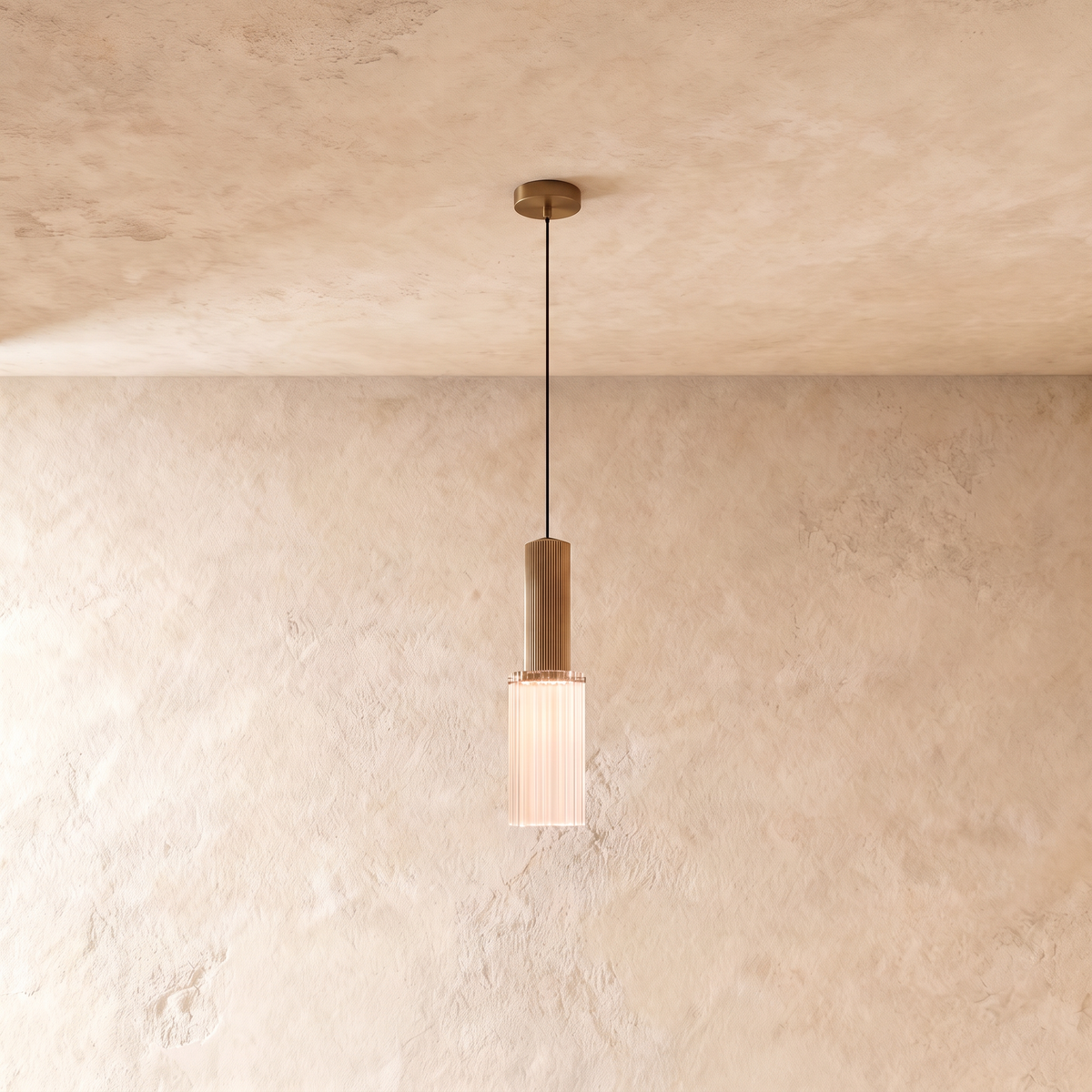 Clérachic slim ribbed glass pendant glowing softly beneath a fluted brass-toned top, hung from a round canopy