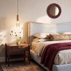 Clérachic slim ribbed glass pendant with a brass-toned top glowing beside a bed and a walnut nightstand