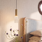 Close view of the Clérachic fluted brass-toned body and vertically ribbed clear glass shade, lit warm