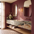 Clérachic slim ribbed glass pendant lit warm between two brass-framed mirrors above a marble vanity