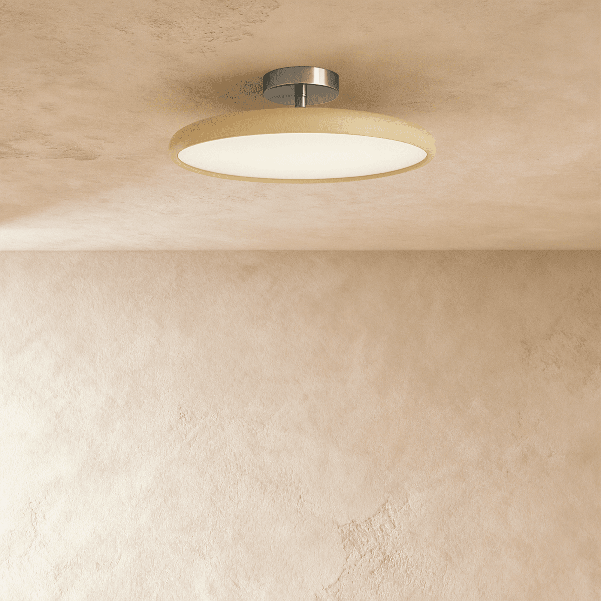 Clérachic slim round ceiling light with a cream rim and glowing white diffuser on a brushed nickel stem, on a limewash ceiling.