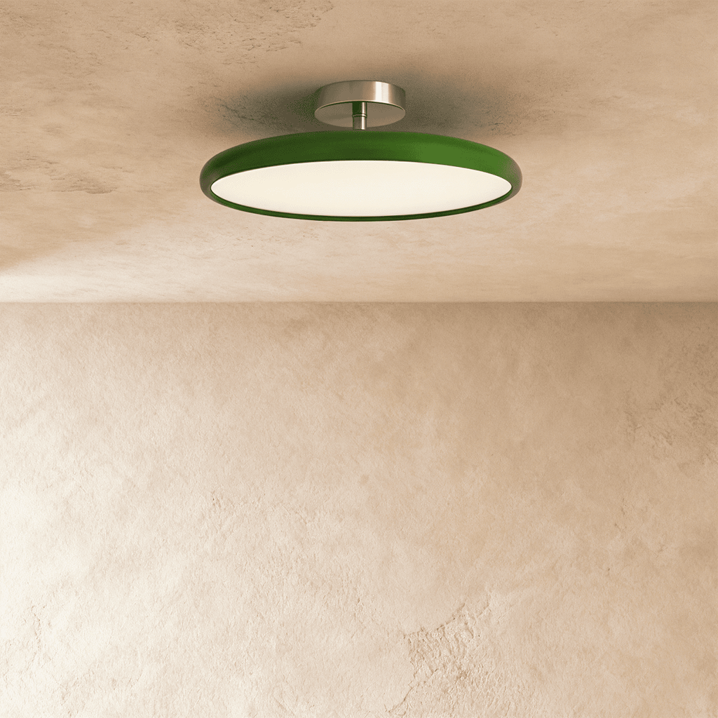 Clérachic slim round ceiling light with a glossy green rim and lit white diffuser, hung from a brushed nickel stem.