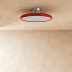 Clérachic glossy red round ceiling light switched off, showing the flat white diffuser and brushed metal canopy.