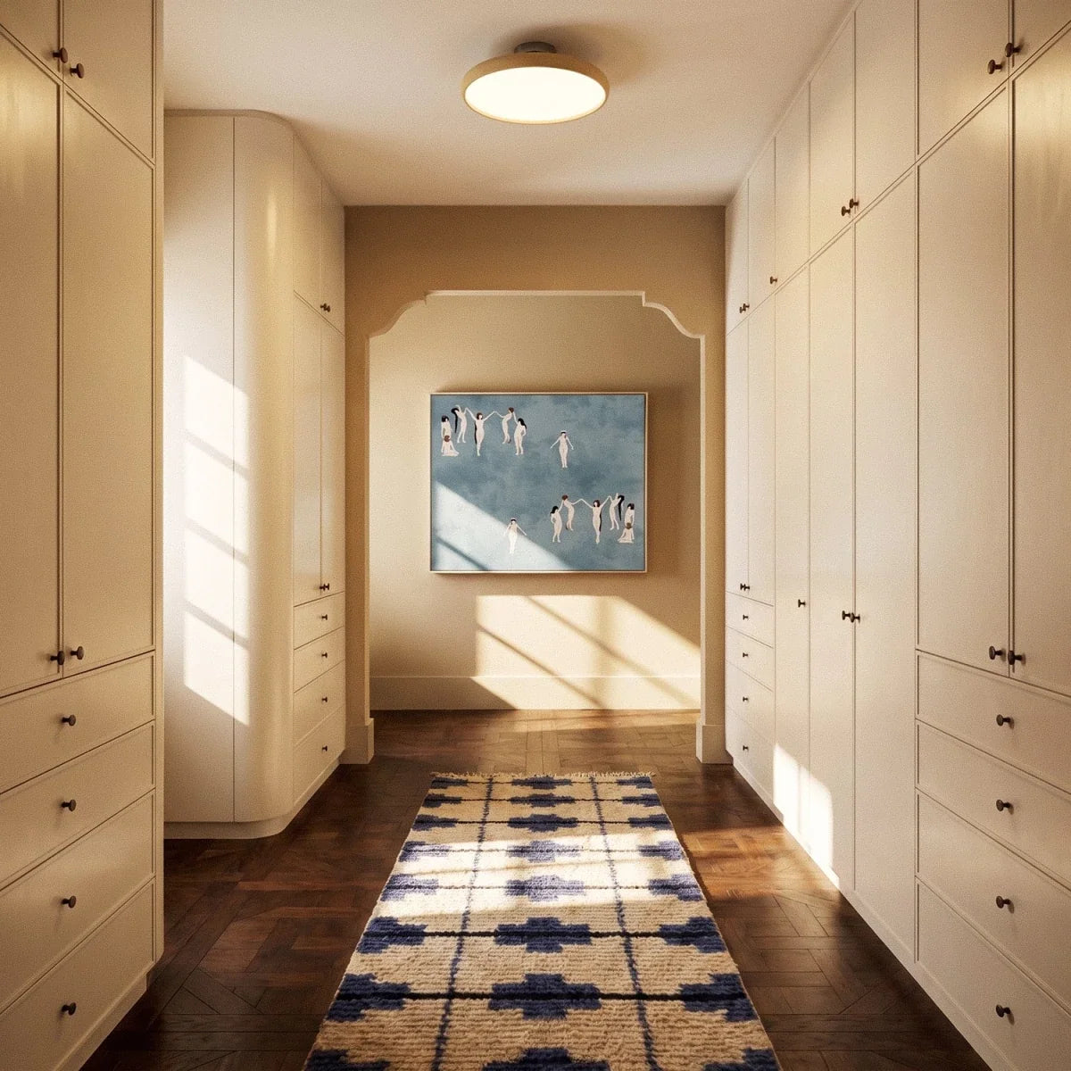 Clérachic cream round ceiling light glowing in a dressing-room corridor of cream cabinets, with a patterned runner below.