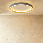 Clérachic grey round ceiling light with a glowing acrylic ring and a brushed gold inner wall, flush on limewash plaster.