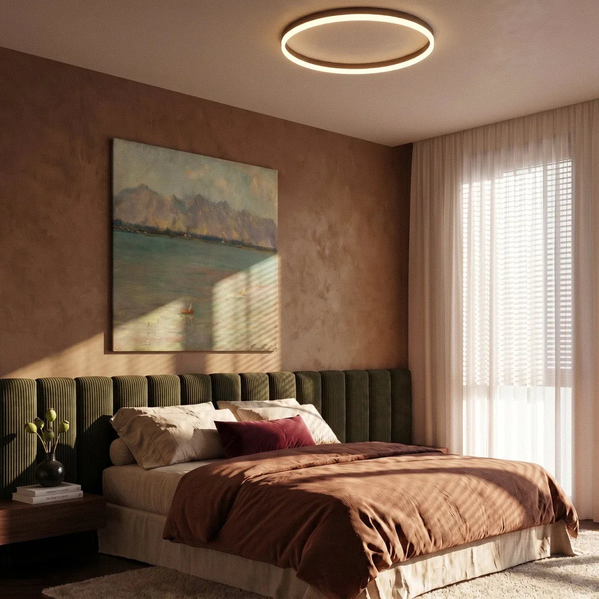 Clérachic slim black round ceiling light glowing warm above a bed with an olive velvet headboard, sheer curtains and a painting.