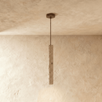 Clérachic slim stone-look cylinder pendant hanging on a thin rod from a bronze canopy, shown in a shorter length.