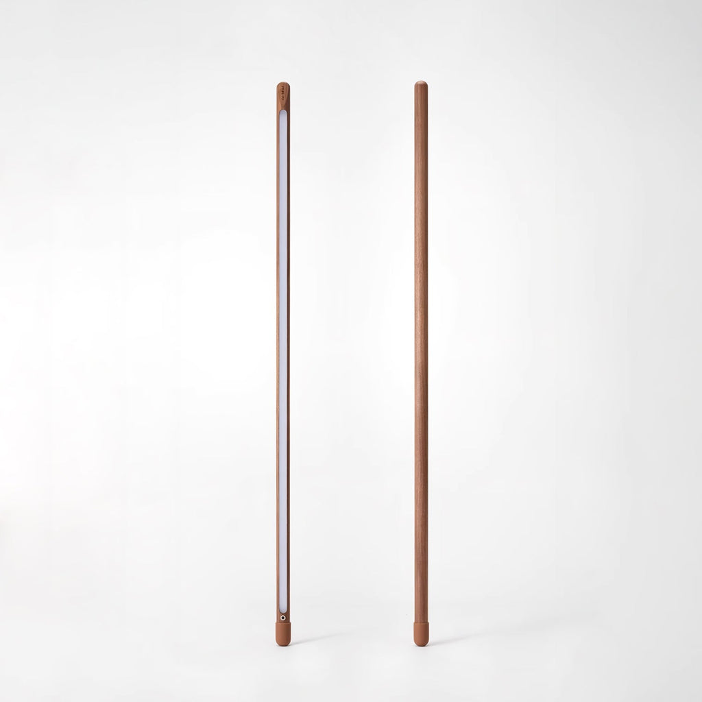 Two Clérachic walnut-colour floor lamps on white, one showing the frosted light strip and one its plain back.