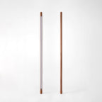 Two Clérachic walnut-colour floor lamps on white, one showing the frosted light strip and one its plain back.