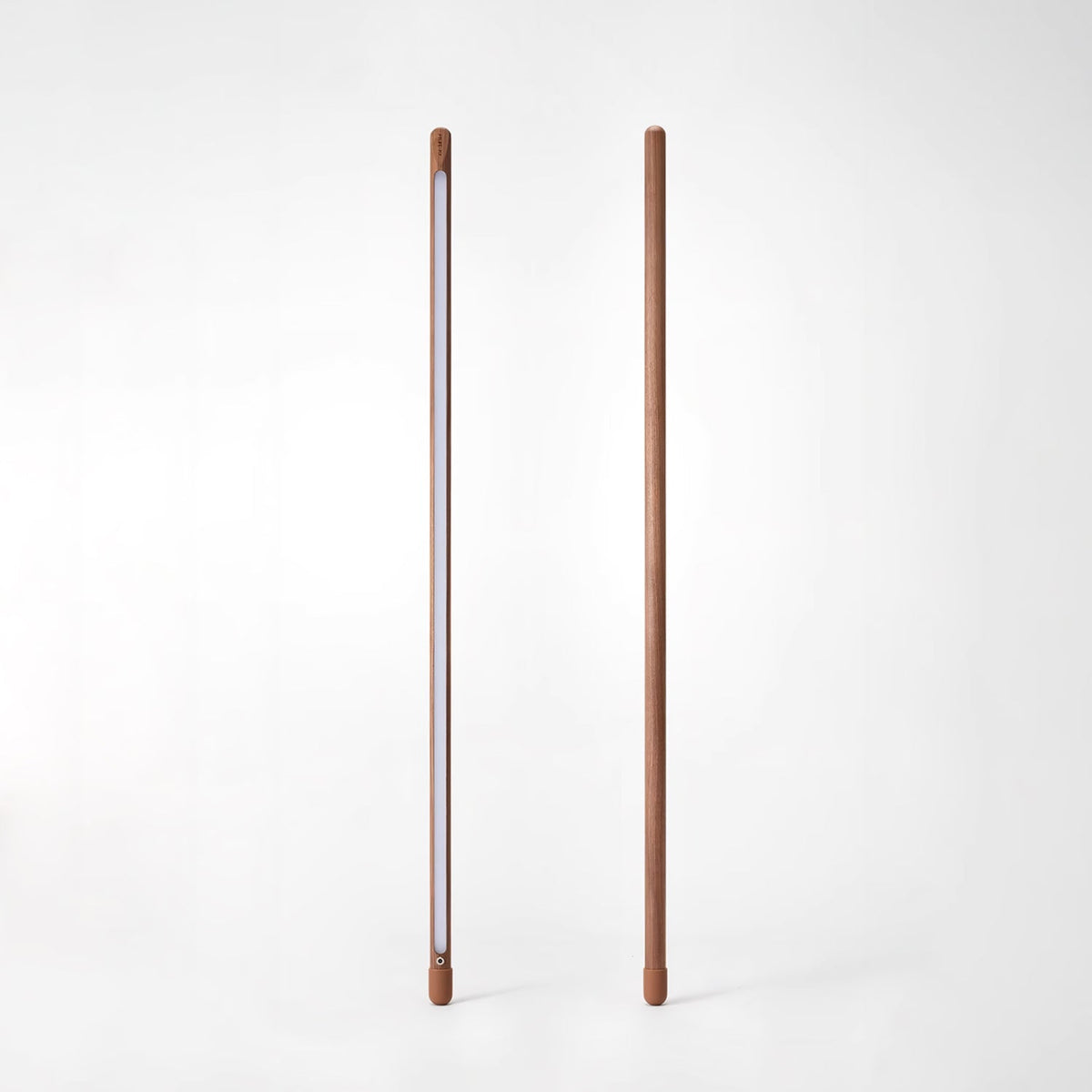 Two Clérachic walnut-colour floor lamps on white, one showing the frosted light strip and one its plain back.