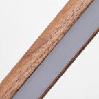 Close-up of the walnut grain and the frosted LED strip set into the body of this Clérachic floor lamp.