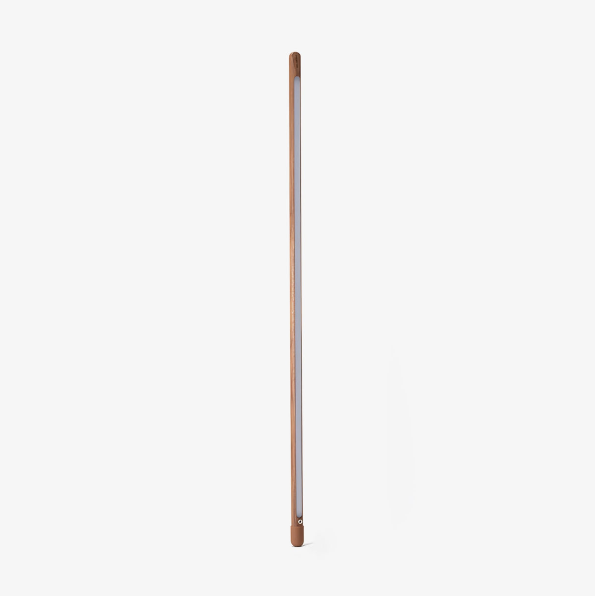 Walnut-colour Clérachic floor lamp standing upright with its frosted strip facing out, on a plain light backdrop.
