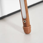 Close view of the foot of this Clérachic floor lamp, with the round power socket, light strip and a terracotta cap.