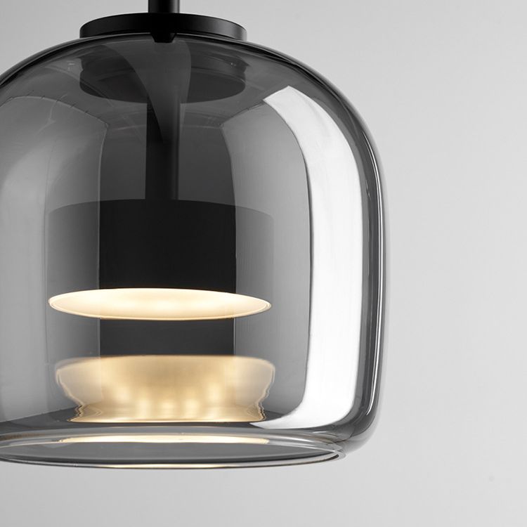 Close view inside the Clérachic pendant's smoke gray dome, where a frosted disc and a wider one below it soften the LED into rings.