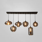 Six mixed shades, flat discs, globes and one cylinder, hang from a black canopy on this Clérachic pendant.