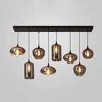 Eight mixed smoke glass shades of this Clérachic pendant, including two cylinders, hang from a black bar canopy.