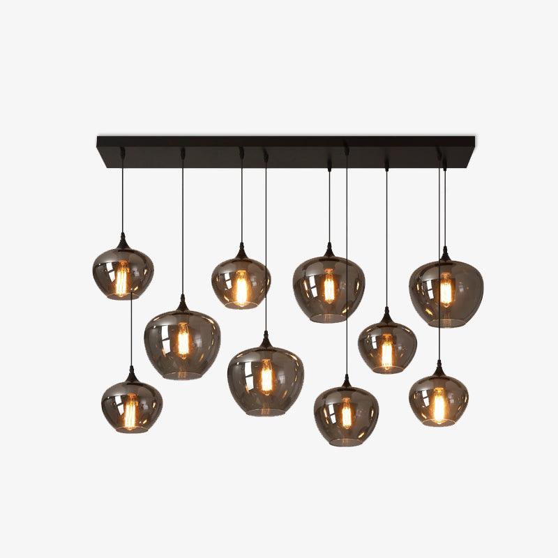 Ten smoke glass globes on this Clérachic pendant hang at varied heights from a black canopy, shown on a white backdrop.