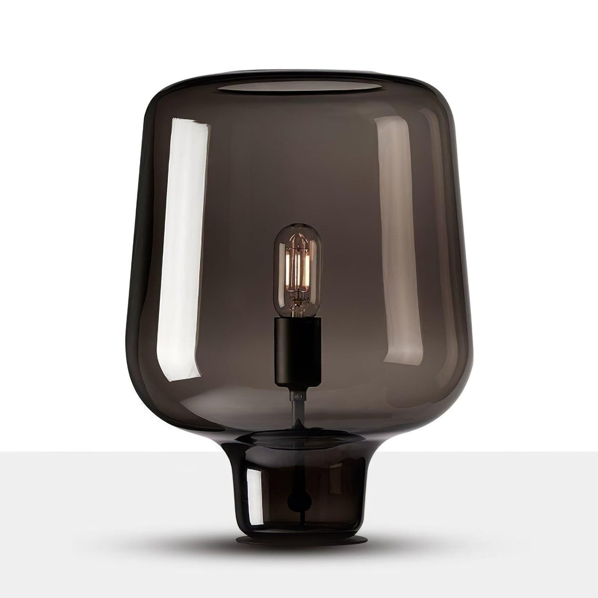 Cut-out view of this Clérachic smoke grey glass table lamp on white, showing the full curved shade and black base ring.