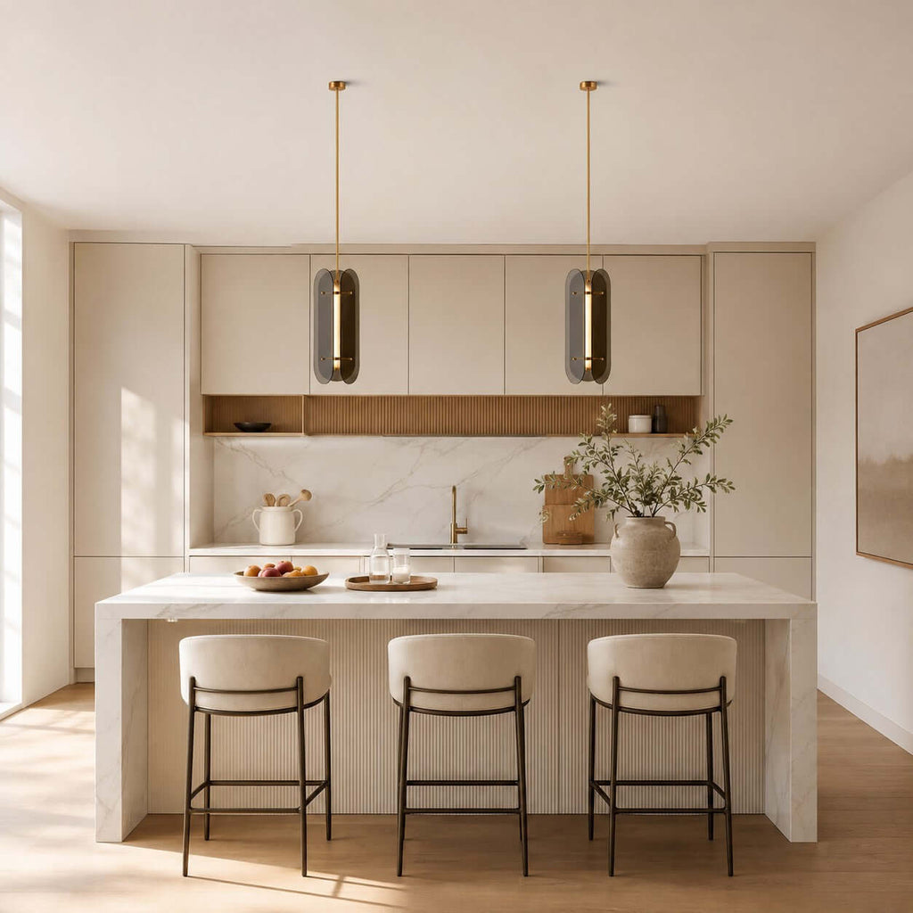 Two Clérachic column pendants in smoked glass hang above a white stone island with three cushioned stools.