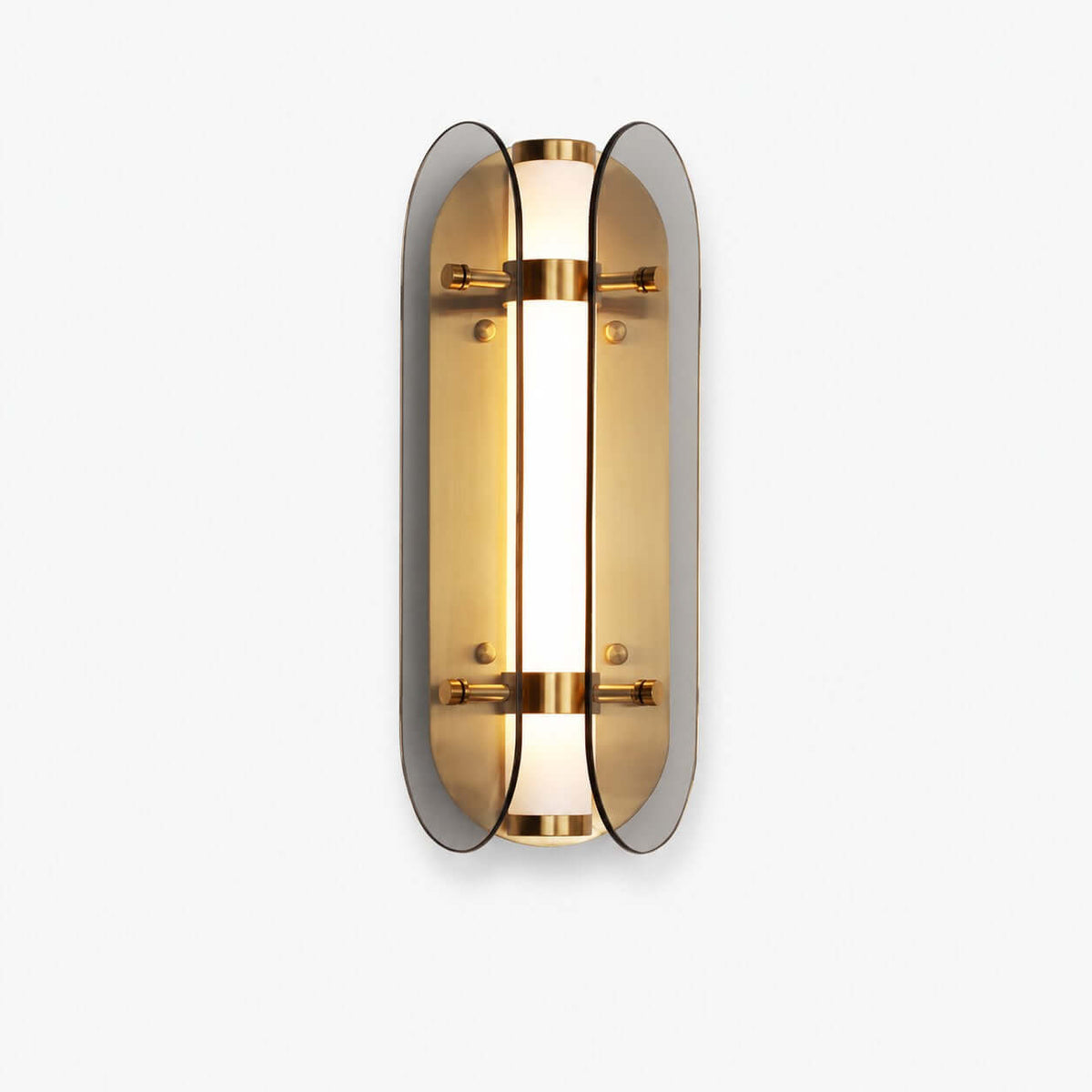 Clérachic wall light with two curved smoked-grey glass wings around a lit, frosted tube and brass bands, on a plain white backdrop.