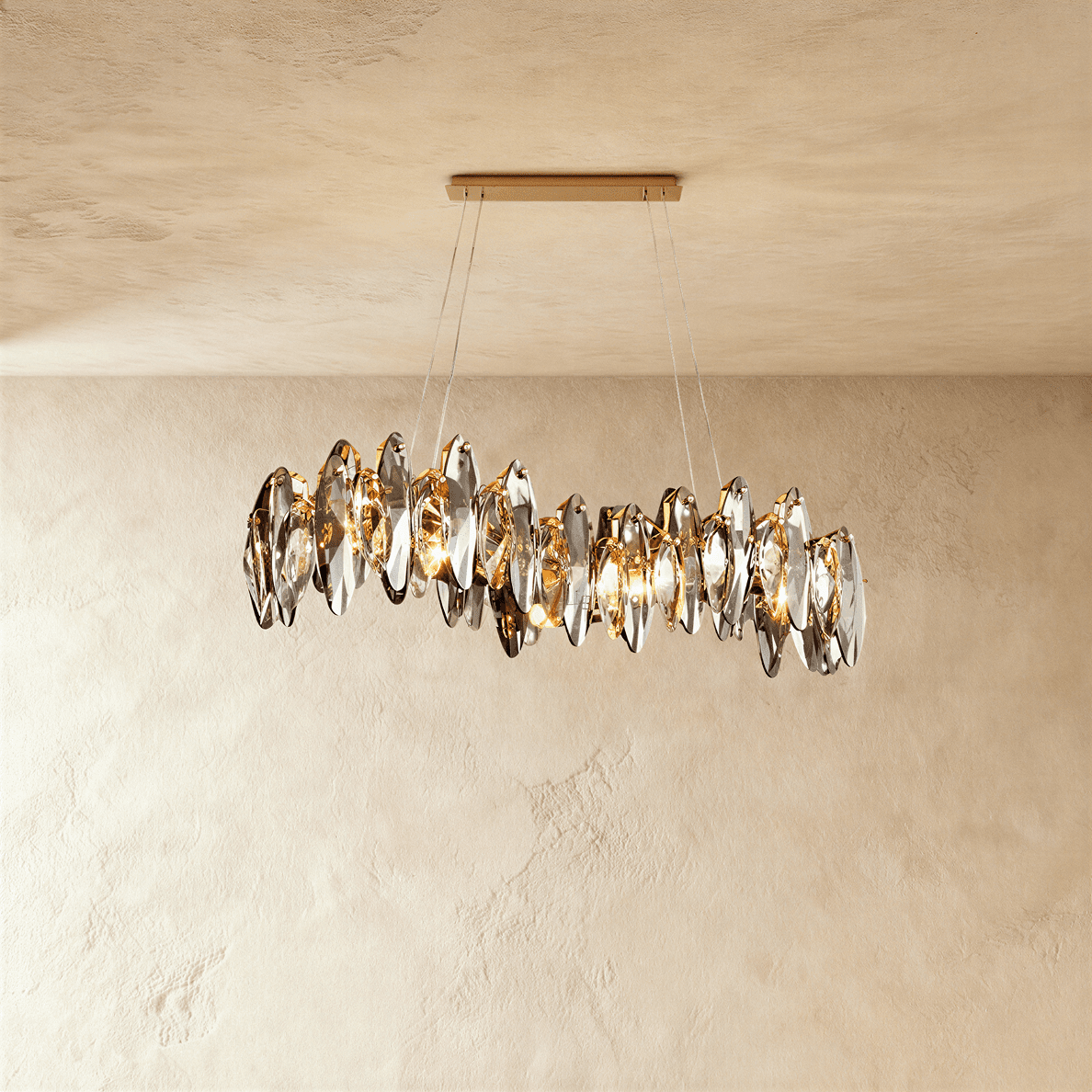 Clérachic long wave-shaped chandelier of smoked crystal leaves on fine wires from a slim gold bar canopy, against limewash plaster.