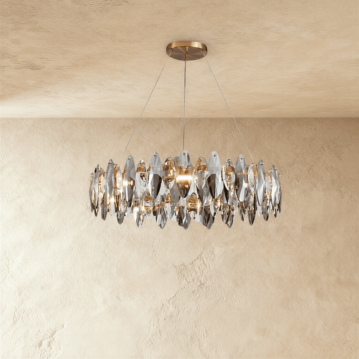 Clérachic round chandelier with a ring of smoked and clear crystal leaves on three fine wires from a brass round canopy.