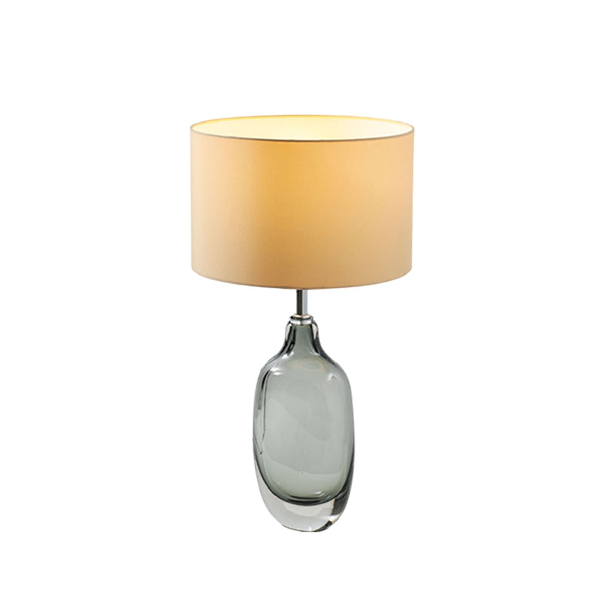 A Clérachic table lamp with a glowing cream shade and a smoky glass base on white, shown at a three-quarter angle.
