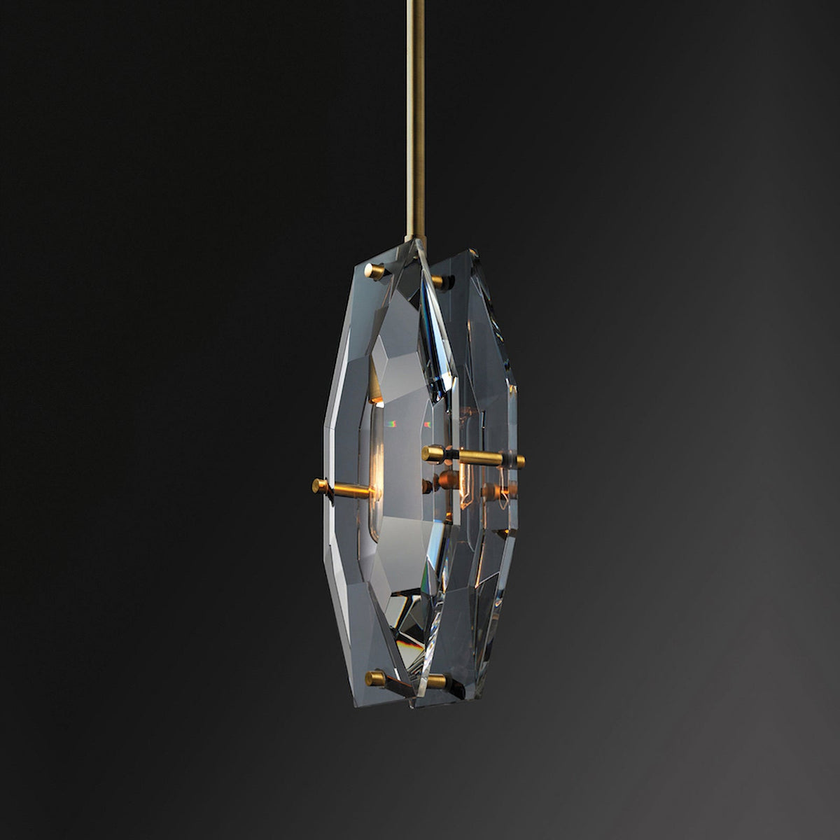 Smoky crystal Clérachic pendant seen at a slight turn on a near-black background, with brass pins at the edges of the panels.