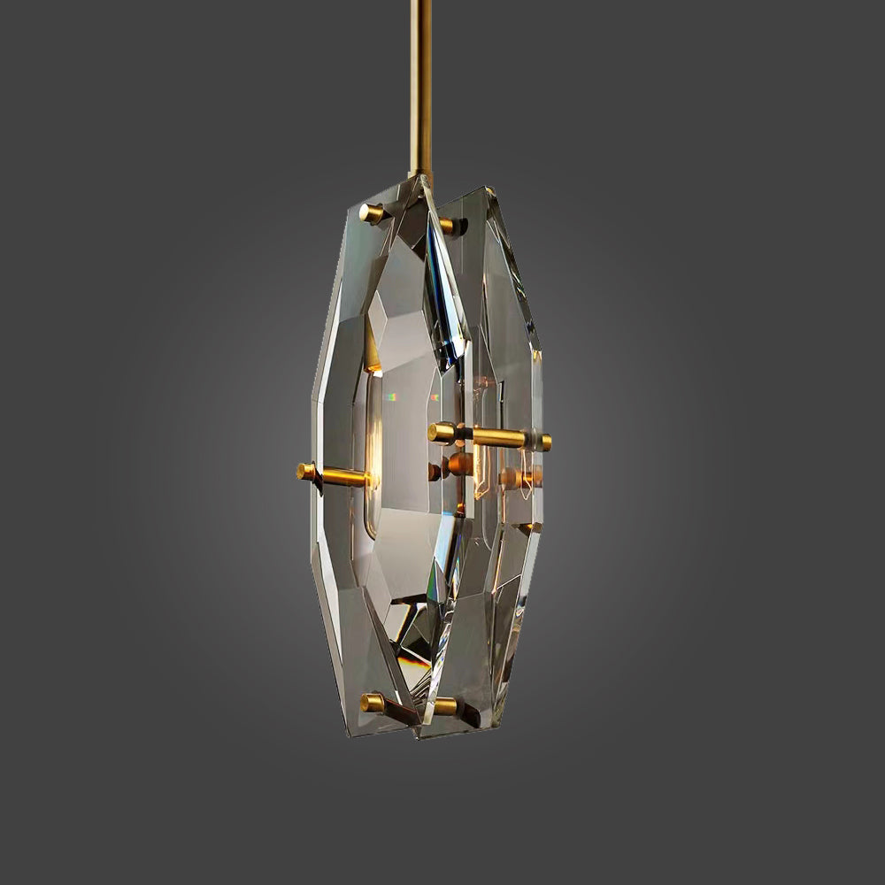 Clérachic crystal pendant on a brass rod, turned slightly to show the thick cut edge of the panels, on a grey studio backdrop.