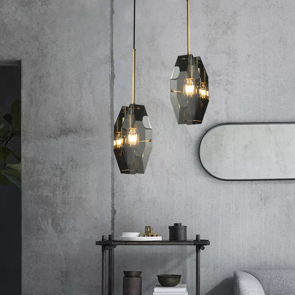 Two smoky grey Clérachic pendants lit at different heights against a concrete wall, with an oval mirror and a dark metal shelf beside them.