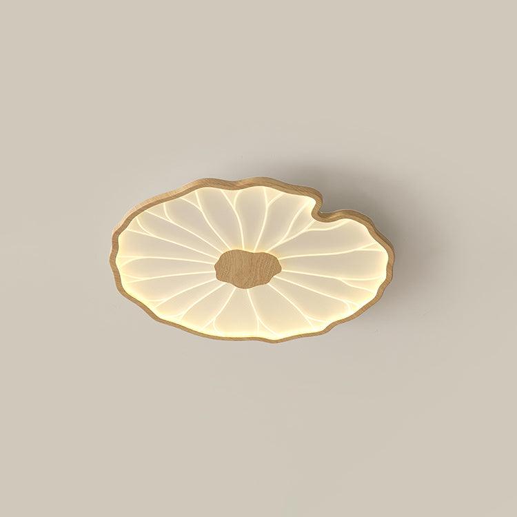 Clérachic ceiling light in a light wood-grain finish, glowing warm against a soft beige ceiling.