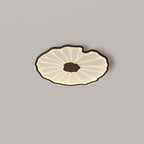The Clérachic ceiling light in a dark walnut finish glows warm on a plain grey ceiling.