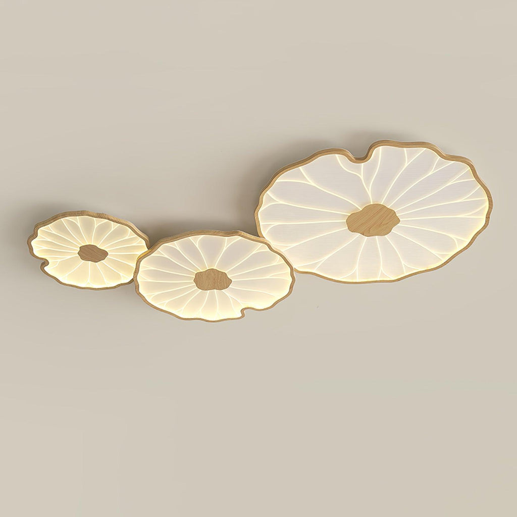 Clérachic three-shade ceiling light in light wood-grain finish, sizes ascending left to right, warmly lit.