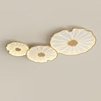 Clérachic three-shade ceiling light in light wood-grain finish, sizes ascending left to right, warmly lit.