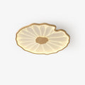Clérachic ceiling light in light wood-grain finish, photographed on a plain white studio backdrop, lit warm.