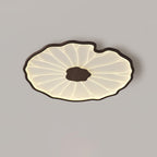 The Clérachic ceiling light in dark walnut finish, warmly lit with a soft shadow cast beneath it.