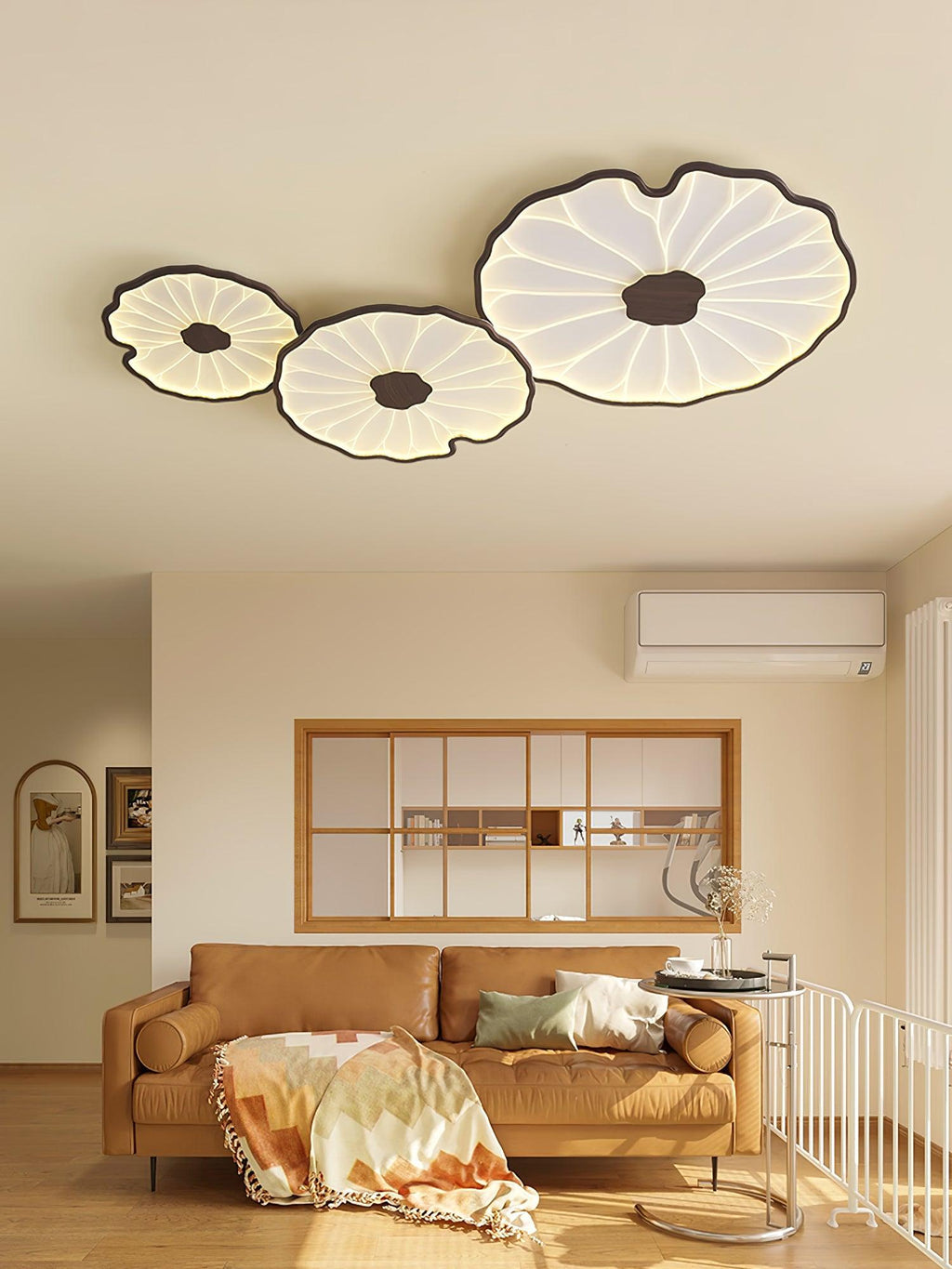 Clérachic three-shade ceiling light in dark walnut finish above a living room with a cognac leather sofa.