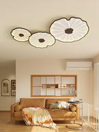 Clérachic three-shade ceiling light in dark walnut finish above a living room with a cognac leather sofa.