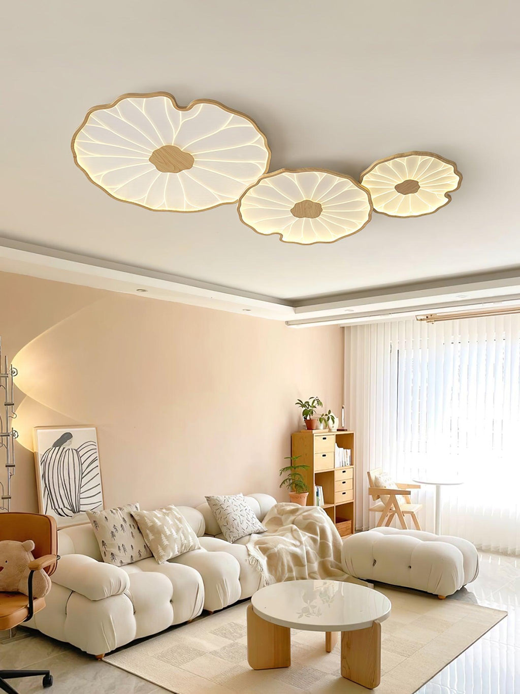 The Clérachic three-shade light in light wood-grain finish, centred above the same terracotta living room.
