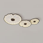 The Clérachic walnut-finish cluster of three shades, a wider crop leaving more grey ceiling in view.
