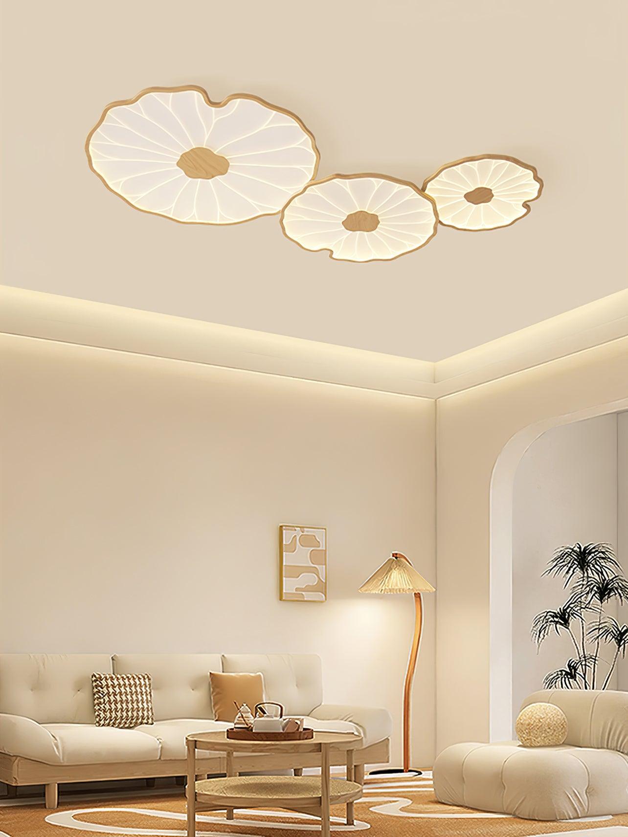 The Clérachic three-shade light in light wood-grain finish above a cream room with a rattan floor lamp.