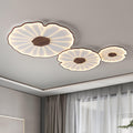 The Clérachic three-shade light in dark walnut finish glows warm near a curtained window in a grey room.