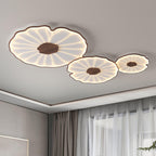 The Clérachic three-shade light in dark walnut finish glows warm near a curtained window in a grey room.